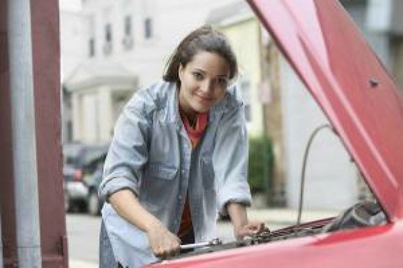 aauto woman fixing car